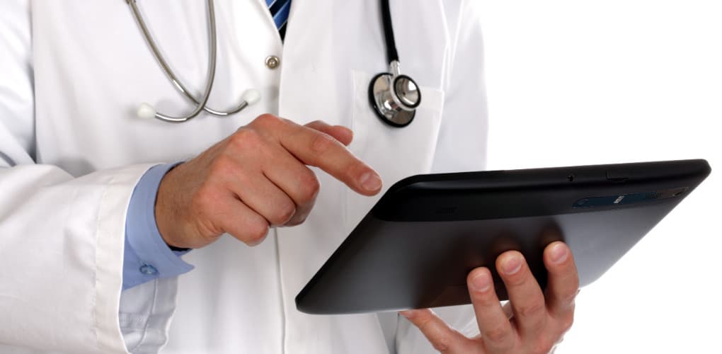 doctor using tablet depicting risks of using copy and paste in EHR