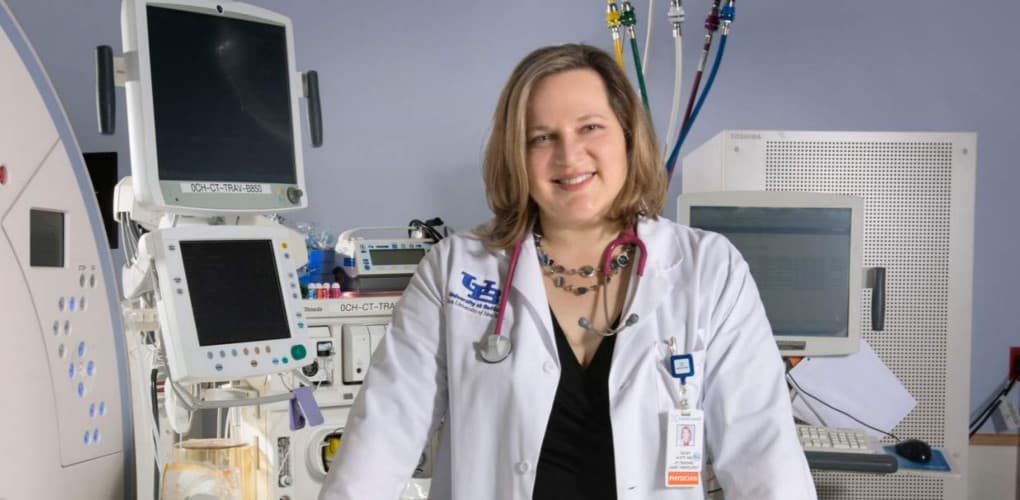 headshot of ECMS President Stacey Watt standing in front of anesthesia equipment