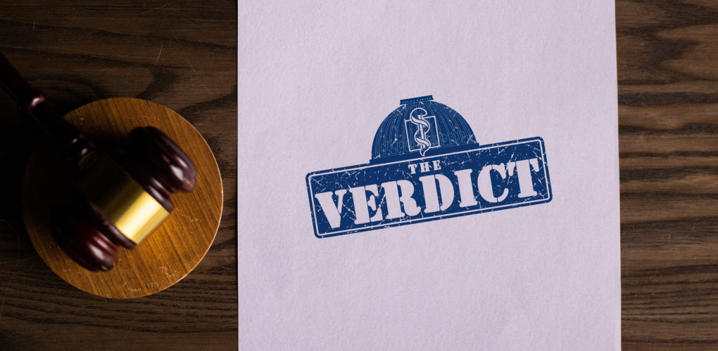 a gavel and a paper reading the word "verdict"