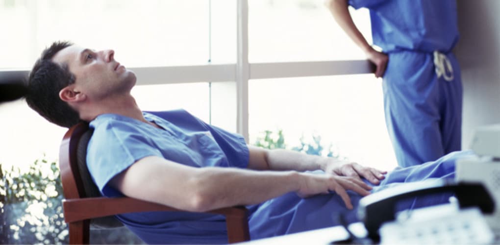 image of healthcare worker in a chair depicting risks of healthcare staffing crisis