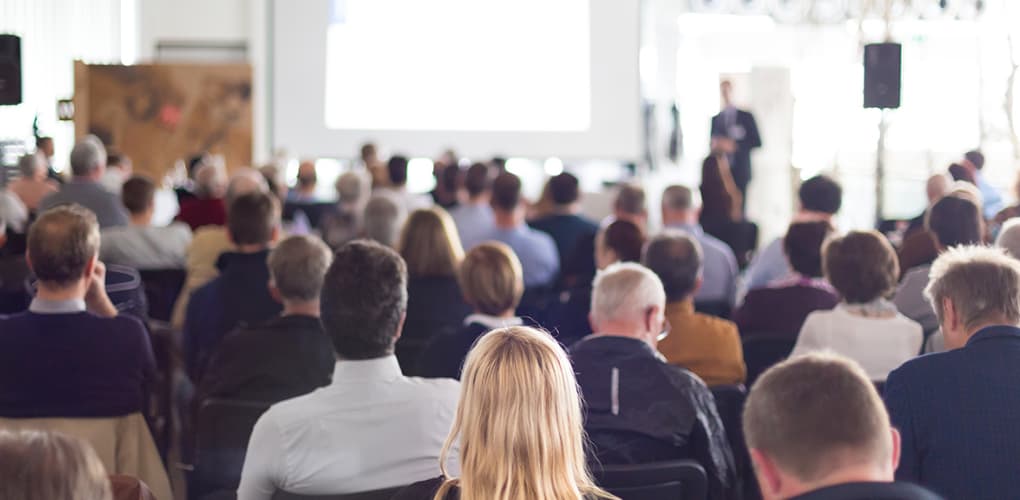 A group of people sit at a March 2024 event for dentists in New York