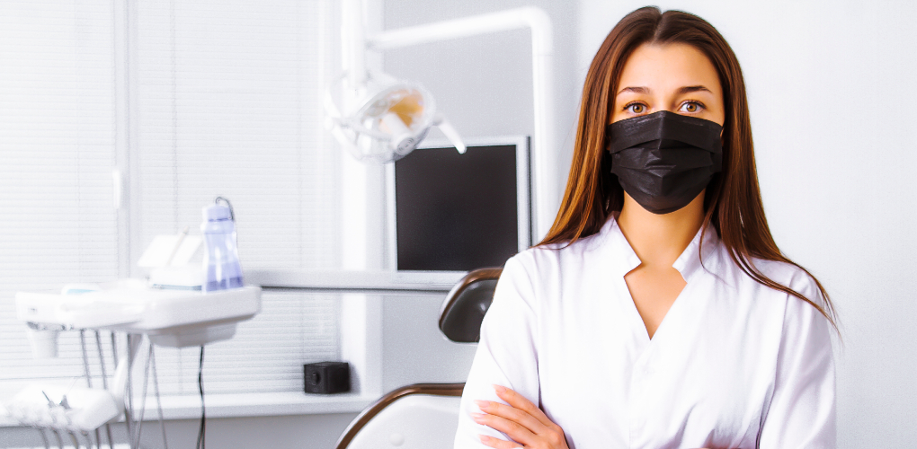 The image for the blog on risk management shows a young female dentist wearing a black mask standing with her arms crossed in a dental office.