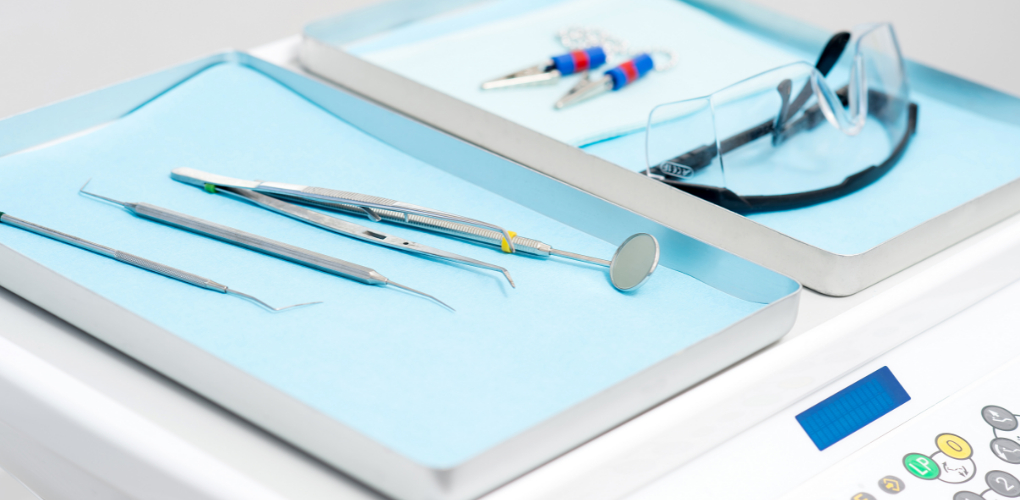 Image shows dental tools on a tray for a blog on how to mitigate liability risks related to technology