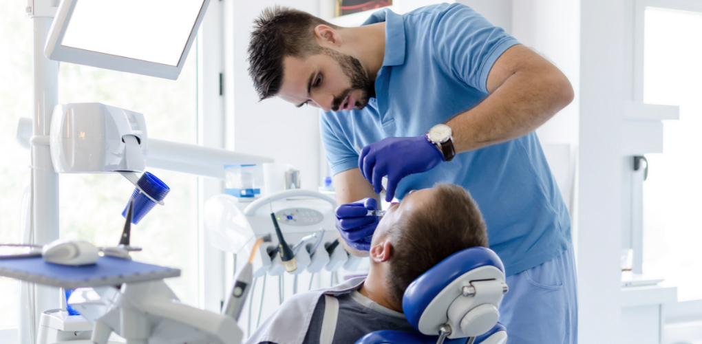 Case study about poor dental patient management with image of dentist caring for a male patient